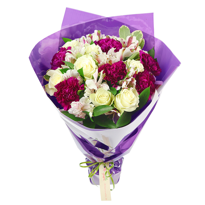 A joyful, carefully arranged bouquet is shown upright against a stark white backdrop, every element clearly visible as if described by a florist familiar with the quiet streets of Grove Park. At the centre sit cream-white roses, their petals tightly furled in spirals that gradually loosen towards the edges, bringing a sense of gentle romance and calm. Embracing them are deep magenta carnations, each head formed of delicate, ruffled petals that create a plush, cushion-like effect, the intense fuchsia shade lending a rich, celebratory tone. Nestled between these bigger blooms are white alstroemeria, or Peruvian lilies, with narrow petals subtly streaked with pinkish-red lines and accented by dark stamens, giving the bouquet intricate detail when viewed closely. A halo of fresh green foliage frames the flowers, some leaves solid and glossy, others touched with pale variegated margins, adding volume, contrast, and a garden-fresh feel similar to the greenery found in nearby Chiswick House Gardens. The bouquet is tied so that the flowers at the top form a rounded dome which then narrows gracefully along the stems, creating a classic, hourglass-like silhouette. Around the stems, a crisp white paper wrap forms a neat collar that supports and showcases the blooms. Over this inner layer, a translucent, softly crinkled purple cellophane or paper is wrapped, catching the light in delicate highlights and adding a modern, festive flair. At the base, a vivid lime green satin ribbon is drawn tight and fashioned into a neat bow, from which a small, rectangular kraft-style tag dangles invitingly, ready for a name or simple message. This arrangement radiates thoughtful celebration, ideal for a birthday, a thank-you, or a just-because gift delivered to a doorstep along Burlington Lane or a cosy home near the river.