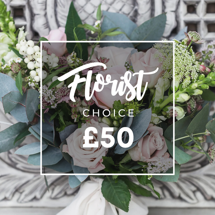 A lush, hand-tied bouquet rests center-frame, its composition balanced between romance and natural texture. Pale blush roses dominate, each with layered, velvety petals that suggest tenderness and celebration, while clusters of bright white berries punctuate the arrangement with crisp highlights. The cool, rounded leaves of dusty blue-green eucalyptus provide a soothing, silvery backdrop and a subtle aromatic quality that feels like an invitation to breathe in. Delicate sprays of tiny white flowers-likely waxflower or astrantia-drift through the arrangement, giving it an ethereal, garden-harvest feel, and smaller, deeper pink or burgundy blooms peek from within, creating depth and warmth. Taller green-and-white spikes, reminiscent of snapdragons, rise gently at the edges to lend vertical movement and elegance. The bouquet is expertly gathered and tied with a soft cream-coloured ribbon, the stems neatly bound to emphasise its bespoke, handcrafted nature. Behind it, an ornate carved stone or plaster wall is softly out of focus, its pale tones amplifying the bouquet's fresh colours and timeless charm. Overlaid on the image is a clean white rectangle with flowing script reading Florist, the word CHOICE below it, and a clear price shown beneath-a visual cue that this is a curated florist's selection. The overall impression is refined yet approachable, perfect for sending across Grove Park or delivering to nearby homes around Chinbrook Meadows and Elmstead Woods as a serene gift for birthdays, thank-yous or quiet congratulations.