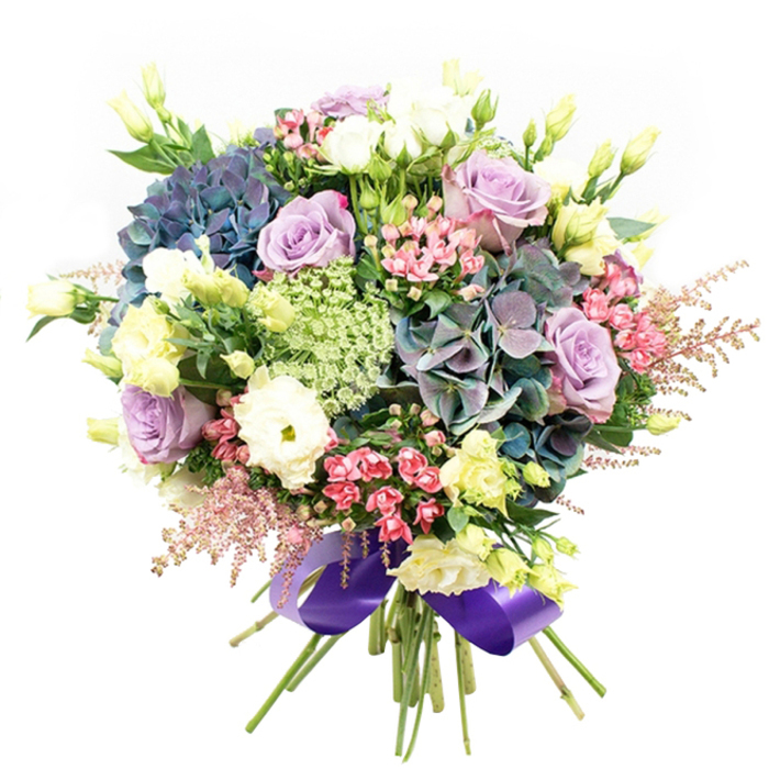 Bursting with the freshness of Grove Park's landscape, this expert floral arrangement is a vibrant celebration of spring. Plump indigo, teal, and violet hydrangea form a textured, voluminous base, their petals layered thickly to evoke the abundance found in local botanicals. Gorgeous roses in soft lavender and creamy white emerge between the hydrangeas, petals delicately spiraled in nods to classic English romance. Tightly packed white ranunculus add ruffled complexity and a tactile beauty, while arching stems of pale yellow eustoma and partially flared blossom heads bring subtle hints of sunlight. The garden-like composition is enriched by dramatic fuchsia-pink filler flowers darting among the primary blooms, and crowned at the edges by feathery pink astilbe that catch the light as if dusted with morning mist from the Thames. Intricate clusters of lacy green-and-white fillers complete the layered look, their fineness reminiscent of riverside wildflowers. A medley of lush green foliage weaves through, accentuating both freshness and structure. Each stem is gathered with precision and tied at the base by an elegant, wide royal purple ribbon, whose sheen adds a final hint of sophistication. Whether destined as a showpiece for a dinner on Grove Park Terrace, a romantic gesture, or simply to fill a home with beauty, this arrangement embodies the lush artistry and welcoming warmth of floristry made for the Grove Park community.