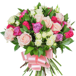 Seen against a bright white backdrop, this lavish bouquet of mixed roses feels like a small garden gathered into a hand-tied bouquet, dense with colour and texture. The dominant flowers are large, fully opened roses in soft pastel pink and creamy white, their petals layered like silk; scattered among them are vivid fuchsia roses that bring lively contrast, and a few gentle lavender roses that cool the composition with a whisper of purple. Interspersed clusters of petite spray roses-mostly creamy white with pale yellow hints at their centers-create delicate variation in scale and a lace-like texture that invites closer inspection. Glossy, deep-green foliage, likely ruscus or salal, frames the flowers and pushes forward in narrow, spear-shaped leaves that add structure and a botanical richness to the overall silhouette. The stems are tightly gathered and finished with a wide, baby-pink satin ribbon tied into a large, flowing bow whose sheen reflects the soft studio lighting and complements the bouquet's romantic tones. This arrangement evokes a gentle, uplifting scent and a tactile softness; each element is placed with experienced hands to balance colour and movement. Thoughtfully suited to personal celebrations, thank-you gestures, and quiet romantic moments across Grove Park and neighbouring Lee and Chinbrook Meadows, this bouquet is the kind of local favourite you might pick up from a trusted neighbourhood florist and present as an intimate, fragrant expression of affection. Crafted with care, it looks at once elegant, cheerful, and reassuringly fresh.