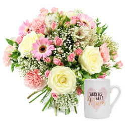 This carefully composed studio photograph presents a heartfelt floral gift set, the kind of thoughtful present a family in Grove Park might choose for Mother's Day or a special birthday. Against a clean white background, the left side is filled with a lush hand-tied bouquet, while the right is anchored by a single white ceramic mug. The bouquet is a harmonious blend of textures and shades: creamy roses, pink gerberas, blush carnations, white alstroemeria, clouds of baby's breath, and a scattering of green foliage. The cream-coloured roses, open to full bloom, show layered, spiral petals that feel rich yet gentle, like a soft hug. Around them, pale pink carnations soften the arrangement with their frilled, playful edges, and vivid pink gerbera daisies with dark chocolate centres add a cheerful note, echoing the upbeat atmosphere of local cafés near Chiswick and Grove Park station. Elegant white alstroemeria with fine reddish-brown flecks weave between the larger blooms, lending a subtle intricacy to the bouquet's surface. Tiny blossoms of gypsophila dot the spaces between flowers, creating an airy, almost mist-like effect, while glimpses of green foliage break up the pastel tones with refreshing contrast. The stems are neatly aligned and gathered, reinforcing the impression of a professionally hand-tied design ready for delivery. To the right, the white ceramic mug stands upright, glossy and smooth. Painted on the front is a light pink heart in a soft, watercolour style, inside which the words "WORLD'S BEST Mum" are printed; "WORLD'S BEST" appears in a dark, straightforward font, while "Mum" is written in shimmering gold script that adds a gentle sense of celebration. The simple, bright lighting keeps shadows minimal and colours true, creating an image that radiates warmth, appreciation, and quiet joy for a special mum in Grove Park.
