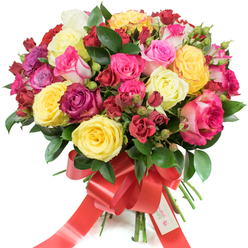 This opulent hand-tied bouquet presents a rich tapestry of roses arranged in a classic dome against a pure white backdrop. Radiant yellow blossoms beam like little beacons, while creamy pale roses temper the brightness and invite a gentle touch. The palette moves through pinks - blush, vivid magenta and soft bicolour petals - into saturated burgundy and crimson accents provided by clusters of smaller spray roses. The florist's technique is clear: larger hybrid tea roses open boldly at the centre while clusters of spray roses and tightly furled buds spiral outward, giving the arrangement movement and depth. Glossy, dark-green foliage - the kind of ruscus and salal we often source at local Grove Park markets - is woven throughout, setting off the hues and lending a fresh, woodland undertone. A broad red satin ribbon is tied around the stems in an elegant bow, its long tails creating a graceful cascade; a neat white gift tag stamped with "Happy Holidays" nestles at the knot, suggesting a seasonal intention. Under soft studio lighting the petals reveal satin textures and subtle veining; one can almost imagine the clean, slightly citrus perfume that lifts from the roses. This bouquet is designed to convey joy, celebration and affectionate sentiment, perfect for anniversaries, congratulatory moments, or as a tender Valentine's or Mother's Day offering delivered locally across Grove Park and nearby streets.