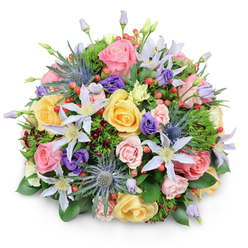 Set against a pure white backdrop, this beautifully rounded bouquet feels like a snapshot of a carefully curated garden, the sort of design you might expect from an experienced Grove Park florist who knows every seasonal nuance. At the heart of the composition, lush garden roses in pastel pink, buttery yellow, and gentle peach unfurl their layered petals, some fully open and generous, others still coyly cupped. Their soft, swirling forms create a sense of romance and tenderness. Woven throughout are starry clematis blooms in white and pale lavender, each one centred with a touch of bright yellow that glows softly and draws the eye from bloom to bloom. Adding a dramatic counterpoint, stems of blue Eryngium-sea holly-rise up with spiky, thistle-like heads, their cool, metallic blue tones standing out against the warm roses, much like the contrast between the leafy serenity of Grove Park and the busier streets beyond. Deep purple lisianthus flowers nestle between these elements, their ruffled buds and open cups lending velvety depth and a gentle, almost whispered elegance. Small clusters of bright red Hypericum berries dot the bouquet, shiny and round, injecting playful notes of colour that suggest celebration and cheer. All of this is held together by abundant foliage: broad, glossy leaves give structure, fine feathery sprigs add softness, and subtle hints of darker burgundy foliage create shadow and dimension. The lighting is soft and even, accentuating the bouquet's dome shape and rich textures without harsh contrasts. This arrangement feels warm and inviting, suitable for marking birthdays, anniversaries, or quiet thank-you moments, and would be a lovely sight gracing a home near the Thames path or delivered to loved ones across Grove Park.