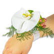 A single, exquisitely composed wrist corsage rests gently on a light-skinned wrist against a pure white backdrop, every detail shown in calm, soft daylight as if photographed in a quiet Grove Park morning. The focal bloom is a pristine white Phalaenopsis orchid - broad, velvety petals unfurl with a serene, almost moth-like grace - and its central labellum draws the eye with a bright yellow wash deepening to a honeyed orange at the throat, a jewel-like contrast to the snow-white petals. Beneath and around the orchid, feathery asparagus fern creates a soft, airy cushion of vibrant green that gives the arrangement a natural, garden-fresh silhouette. To the upper right of the flower sits a small cluster of glossy Hypericum berries, their skin catching the light as colours slide from pale green through warm rose to a deep crimson, suggesting harvest-time richness and visual rhythm. A few ruffled, lime-green accent leaves thread among the berries, adding crisp texture and a modern pop of chartreuse. The whole cluster is secured on the wrist by a classic, multi-strand bracelet of tiny white pearls that lie cool and smooth against the skin, lending vintage charm and comfortable wear. The composition smells faintly floral, with the orchid's subtle sweetness and the green, almost grassy note of the fern; it reads as timeless and romantic, perfect for a wedding, prom, or an intimate celebration near Chinbrook Meadows or the Grove Park Nature Reserve. As a florist's piece, it balances delicate craftsmanship with wearable comfort: the white background keeps the eye on texture and hue, and the overall impression is one of refined elegance and quiet joy.