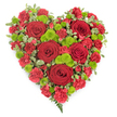 In this photograph, a meticulously arranged heart-shaped floral tribute is shown against a clean white background, allowing the deep reds and fresh greens to carry the full emotional weight of the design. The heart is richly packed with flowers, dominated by several large red roses whose velvety petals spiral tightly, drawing the eye into their shadowed centres. These roses sit like anchors within a sea of smaller red carnations, each bloom with ruffled, gently curled petals that overlap and blend together, creating a soft, cushion-like texture across the entire heart. Punctuating the red, clusters of bright lime-green button chrysanthemums appear at intervals, their small, domed heads and intricate pattern of florets bringing a lively contrast and preventing the composition from feeling heavy. Around the outer curves and subtly woven among the flowers, variegated foliage with green and cream markings provides a natural frame, softly defining the heart's silhouette and adding layers of interest. At the pointed lower end, a few delicate fern-like fronds extend beyond the floral mass, giving an elegant finishing flourish. The overall effect is of a full, carefully shaped heart that speaks of love, remembrance, and respect, the sort of tribute that might be delivered to a Grove Park family home or set beside a memorial near the quiet streets and green corners of the area. It reflects the care and sensitivity of the florist, using fresh, vivid flowers to offer comfort and a tangible symbol of enduring affection during a time of loss.