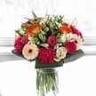 With every glance, this Grove Park bouquet suggests an exuberant festival of colour and life. Radiant orange gerberas, like bright lanterns swaying in a breeze over Grove Park Green, bring a cheerful warmth that is echoed by the fresh blush of pink roses and the plush, velvety texture of striking magenta carnations. Balanced carefully with creamy ivory roses and serene, peach-toned gerberas, the arrangement gains a sense of gentle sophistication and heartfelt affection. Glossy emerald greens embrace the composition, their crisp edges providing a sensation of fullness and vitality that echoes the local landscape after rainfall. The photograph's luminous lighting magnifies every detail, making textures and shades shimmer in perfect harmony. Ideally designed for joyous milestones or as a thoughtful pick-me-up, this bouquet embodies the artistry and seasonal sensibility found in Grove Park. Each stem reflects not just floral mastery but a genuine care for community, infusing every delivery with a sense of belonging and delight.