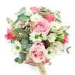 The photograph shows a romantic, garden-inspired hatbox arrangement viewed from just above, its rounded top of flowers standing out clearly against a pure white background. The container is a blush-pink round box, topped with a generous dome of blooms in soft pinks, whites, and greens that would sit beautifully on a Grove Park windowsill overlooking the trees. Light pink roses are positioned throughout the bouquet, some fully open with plush, spiralling centres, others in earlier stages of bloom, giving the design dimension and the feeling of a moment gently unfolding. Clustered around them are white daisy-like chrysanthemums, each with a vivid green heart that adds brightness and a touch of playfulness to the otherwise serenely romantic palette. Threaded between these are white alstroemeria, or Peruvian lilies, their slender petals etched with purplish-red streaks and fine speckles, bringing delicate pattern and a hint of the exotic. The arrangement is framed and filled by varied foliage: rounded eucalyptus leaves in a soft, silvery-green hue create a cool, misty background, while longer, darker green leaves weave through the flowers to create structure and movement. Tucked discreetly among the greenery are small groups of reddish-brown buds or berry-like accents, which introduce subtle warmth and reinforce the natural, garden-fresh feel, as if gathered after a walk near the Thames Path. Around the middle of the hatbox, a narrow reddish-pink satin ribbon is tied, from which a cream rectangular tag hangs, printed with a simple logo that complements rather than competes with the flowers. The overall mood is one of gentle luxury and heartfelt sentiment, ideal for celebrating birthdays, anniversaries, or sending a tender message with same-day flower delivery around Grove Park.