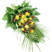 A serene, teardrop-shaped funeral spray is pictured against a bright white background, capturing every nuance of colour and form as though laid out in a tranquil space near the quiet back streets of Grove Park. The arrangement flows from the top left, where the stems are neatly bound together, to the bottom right, where the foliage tapers delicately. At the centre of the spray sits a generous grouping of yellow roses-some fifteen to twenty blooms in total. These roses display a range of opening stages: a few remain as compact buds, while others blossom into more open forms, their petals unfolding in soft spirals of warm golden yellow. Intermixed with the roses are clusters of small, round, bright red berries, most likely Hypericum. Their smooth, shiny surfaces create a subtle sparkle throughout the design and offer a striking contrast to the velvety rose petals. Supporting and framing the flowers is a carefully arranged mass of greenery. Broad, dark green leaves overlap and fold at the top left, creating a substantial base that anchors the composition and shows the hand of a skilled florist. Extending from the opposite end are long, slender palm fronds, each lined with narrow, pointed leaflets that fan out gently, lending the spray length and a sense of directional movement. The textures-soft petals, firm berries, sleek leaves-combine to create a piece that feels both comforting and composed. Overall, the spray communicates respect, remembrance, and quiet solace, an ideal floral tribute for a funeral or memorial in Grove Park, resting beside a coffin, an urn, or a cherished photograph during a final farewell.