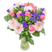 There's a gentle poetry in this bouquet-soft pink roses and pale gerberas gathered in Grove Park, each bloom glowing against a backdrop of rich greenery as if lit by the afternoon sun near Chiswick Station. The roses peel back their silken petals in shy, pastel blush, evoking feelings of young love or heartfelt appreciation, while vivid violet statice nestles amid the blooms, their papery textures and lively hues adding a spark of cheerful spontaneity. The foliage is deep and abundant, conjuring the tranquility of the local riverside parks. Housed in a transparent glass vase, the arrangement is airy yet complete-crafted for moments big and small. Whether it's a birthday surprise for someone on Grove Park Gardens, a congratulatory gesture, or a token of affection when words are not enough, every flower is chosen for its beauty and emotional resonance. The bouquet's balanced composition and soft colours are a tribute to Grove Park's serene character, ensuring any recipient feels cherished and uplifted.