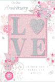This anniversary card seems to capture the soft intimacy of an evening by the Thames near Grove Park, when conversations become low and tender. The design is built around the word LOVE, presented in raised, softly curved letters coated with fine glitter that gleams as the card is tilted, adding a sense of special occasion. The letter O transforms into a shimmering silver heart, its textured surface offering a pleasant, tactile focus, much like the reassuring weight of a cherished keepsake. The surrounding artwork is a gentle arrangement of blooms in blush and mauve tones, their petals blending with a watercolour-style softness. The lines remain fine and fluid, as if an experienced florist has translated the memory of a favourite spring garden into ink and paint. Scattered around the flowers are subtle decorative touches-tiny petals, swirling lines, and discreet butterflies-that lend movement and a whisper of whimsy. Soft pastel pinks and silvery greys dominate the palette, creating an atmosphere of privacy and warmth, like a conversation kept just between two people. The card bears scripted phrases such as On Our Anniversary and I love you today and always, written in a flowing, modest script that supports rather than competes with the central floral and heart motif. The composition feels thoughtfully balanced, with each visual element given room to breathe, similar to the way a carefully arranged bouquet requires just the right amount of space between stems. This card would sit beautifully alongside a vase of fresh flowers delivered around Grove Park, offering a paper keepsake that mirrors the tenderness, history, and hope carried in an enduring relationship.